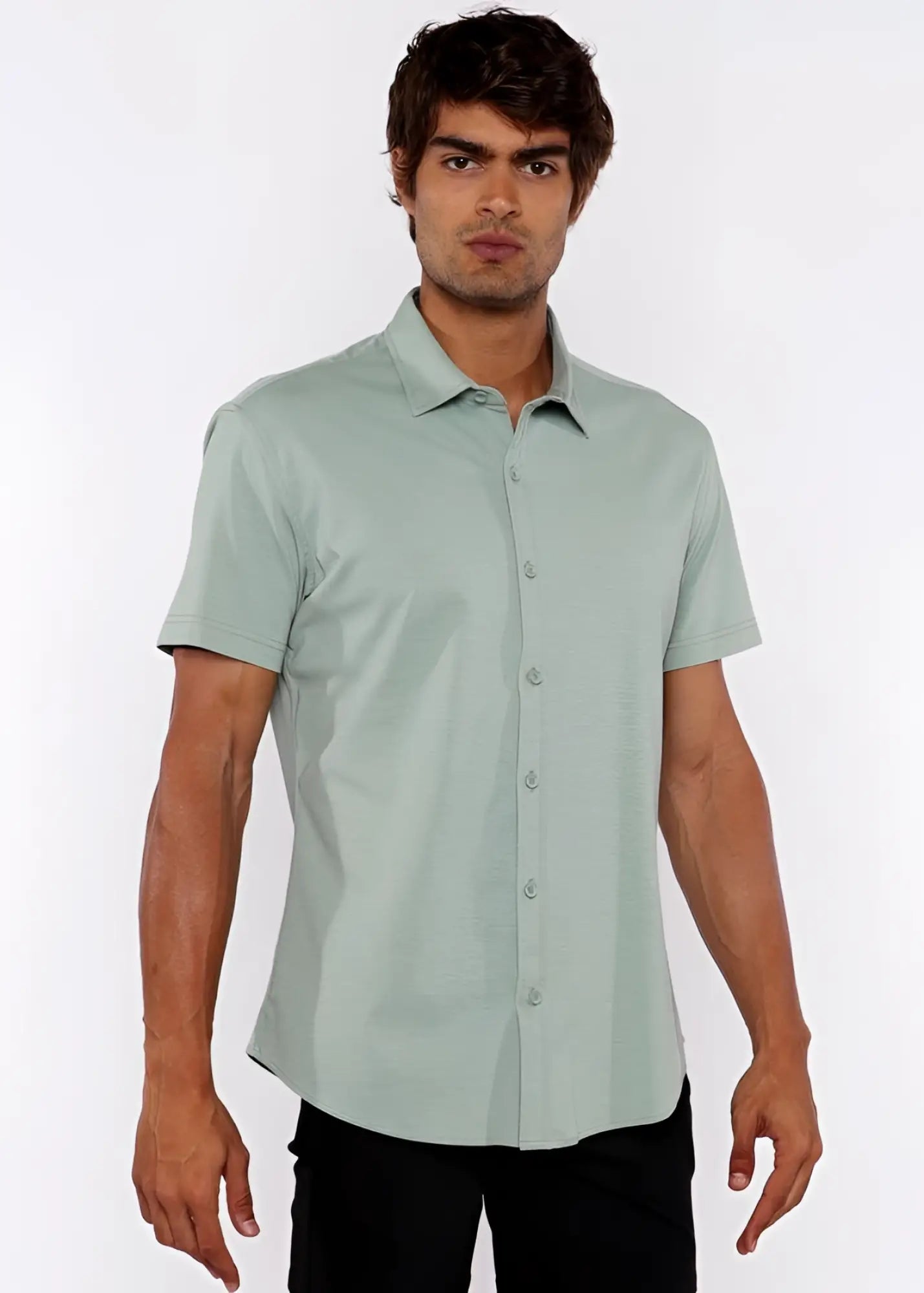 A man wearing a light green stretch knit shirt with short sleeves and a classic collar in neatly pressed fabric