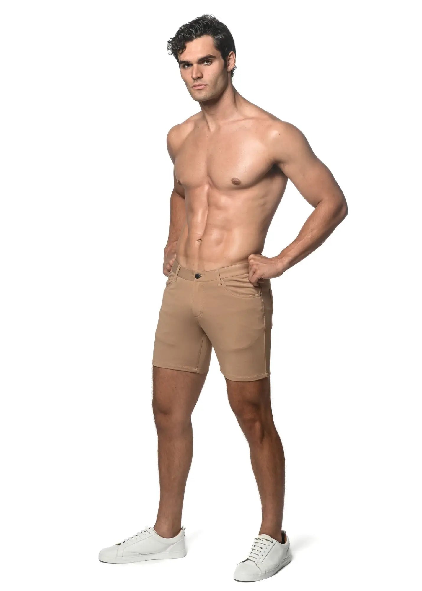 Beige stretch knit athletic shorts with tailored fit and classic five-pocket design for versatile wear