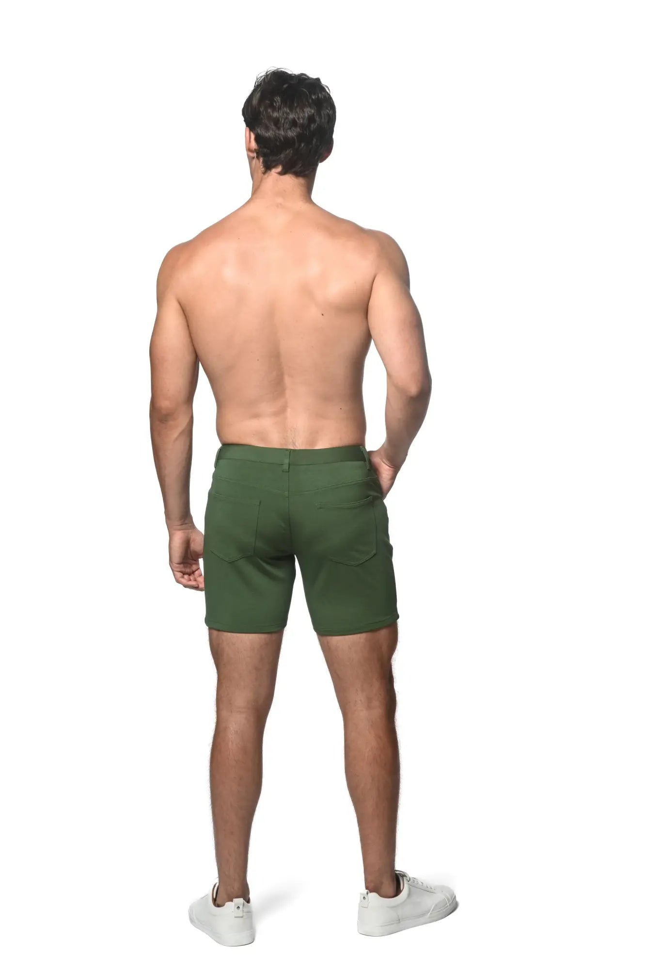 Dark green stretch knit shorts with a tailored fit classic design and visible back pockets shown from the back side