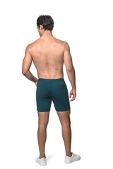 Dark teal stretch knit shorts with a sleek modern design and subtle side pockets for athletic use