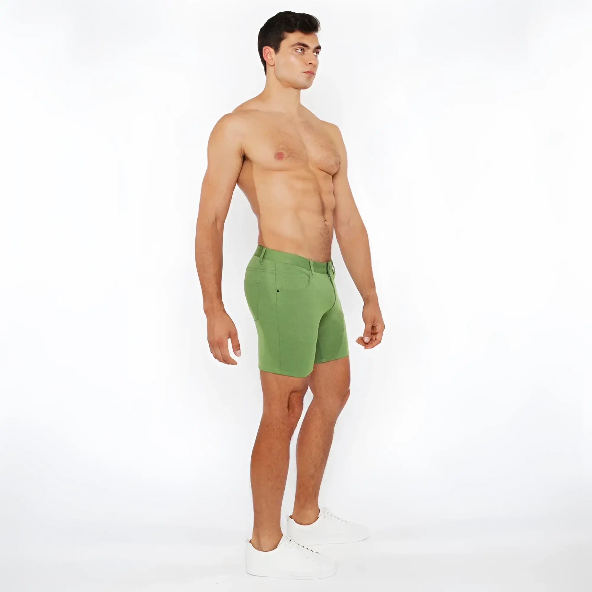 Green stretch knit short athletic shorts with fitted cut and visible stitching details for active wear