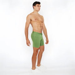 Green stretch knit short athletic shorts with fitted cut and visible stitching details for active wear