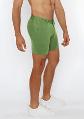 Green stretch knit shorts with classic five-pocket design and belt loop waistband in denim fabric