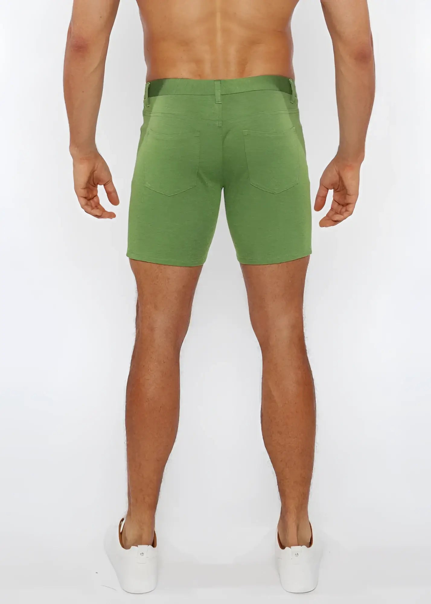 Green stretch knit shorts with straight-leg cut and rear pockets shown from the back side