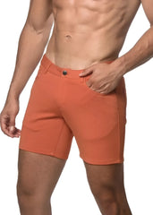 Orange stretch knit shorts with button closure and side pockets ideal for athletic activities