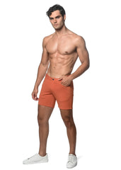 Orange stretch knit short athletic shorts with sleek modern design and subtle side pockets