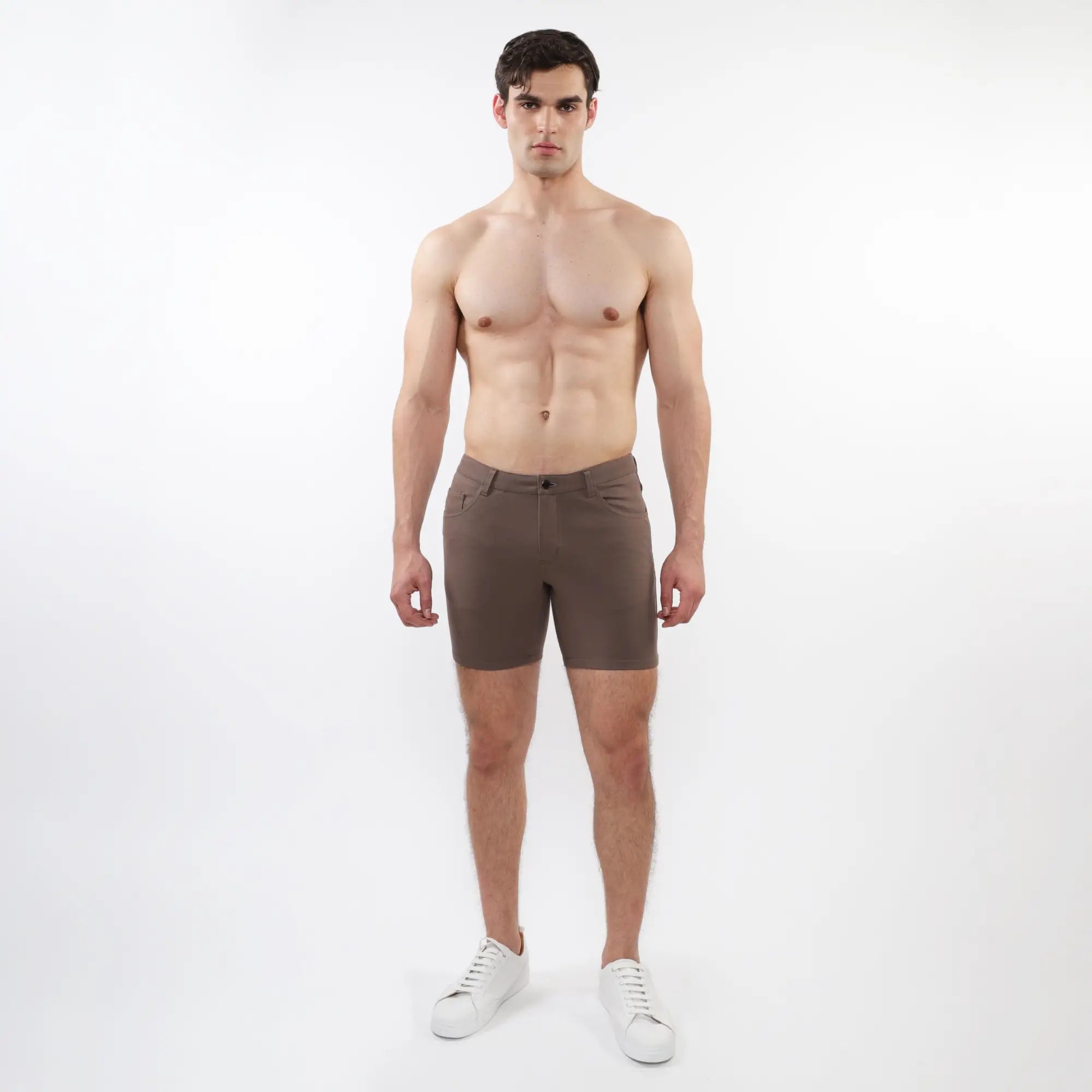 A pair of dark brown slim-fit stretch knit shorts with modern design and subtle stitching details