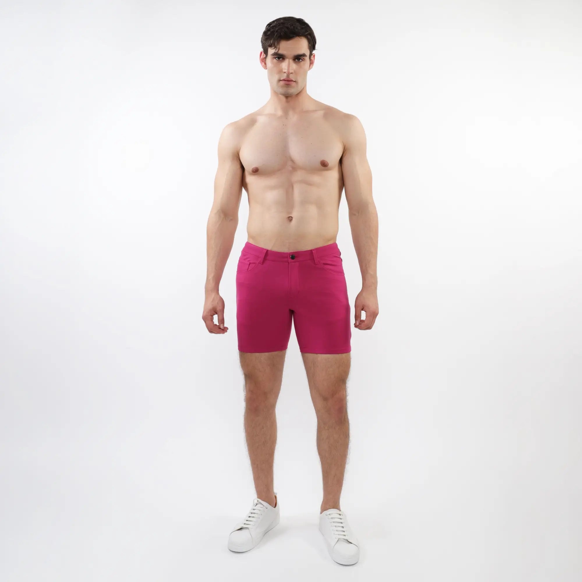A pair of vibrant fuchsia stretch knit shorts with a form-fitting modern design and subtle stitching details