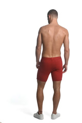 Red stretch knit athletic shorts with tailored fit and visible back pockets shown from the back side