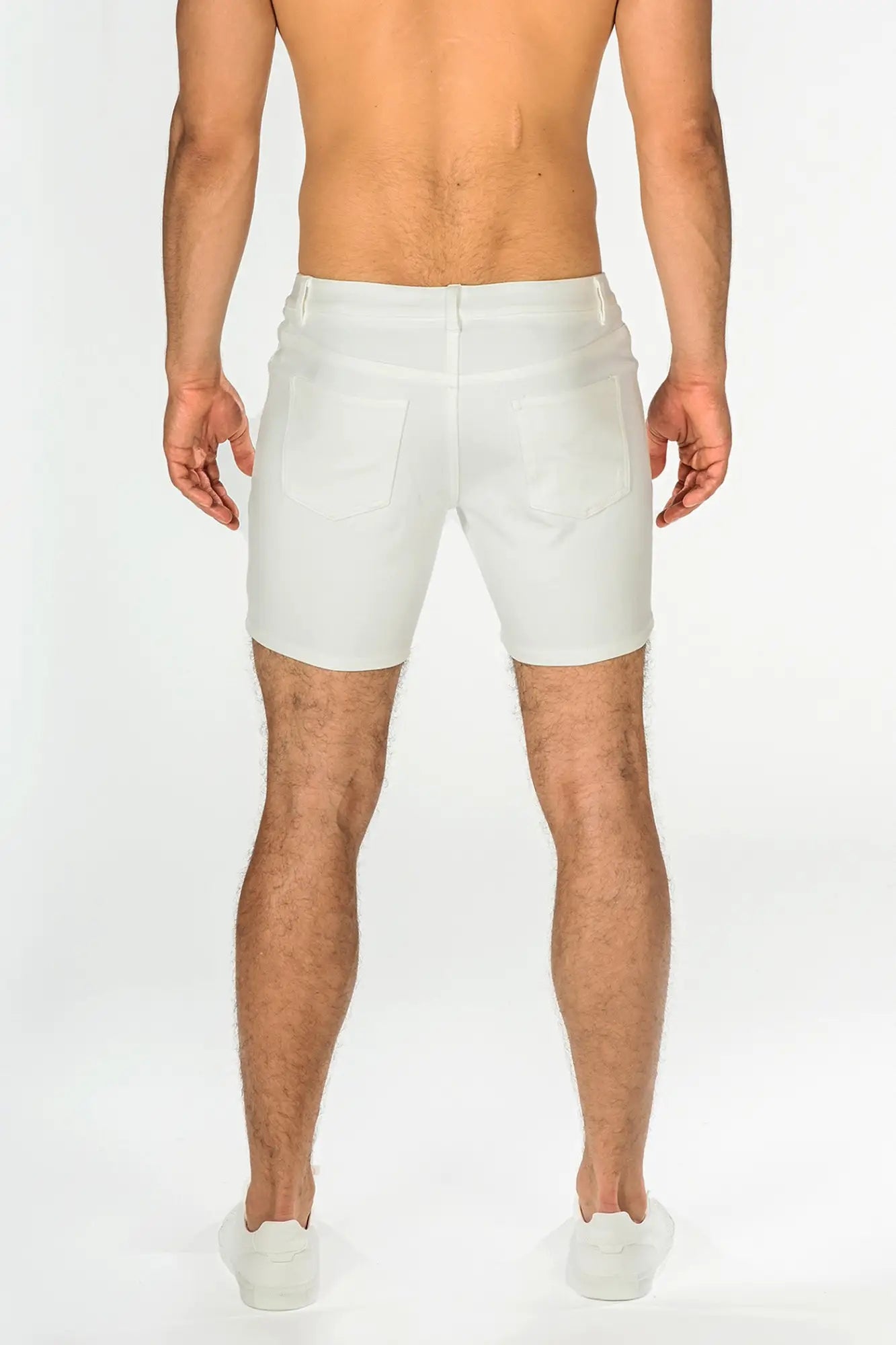 White stretch knit short denim shorts with tailored fit and classic back pockets shown from the back side