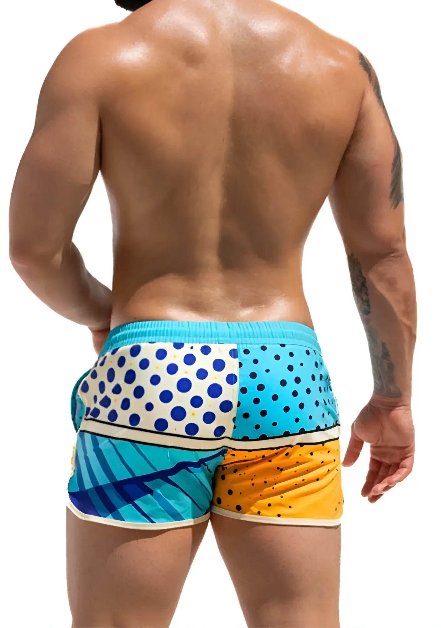 Vibrant super dog swim short featuring patchwork swim trunks in turquoise white blue polka dots and yellow orange hues