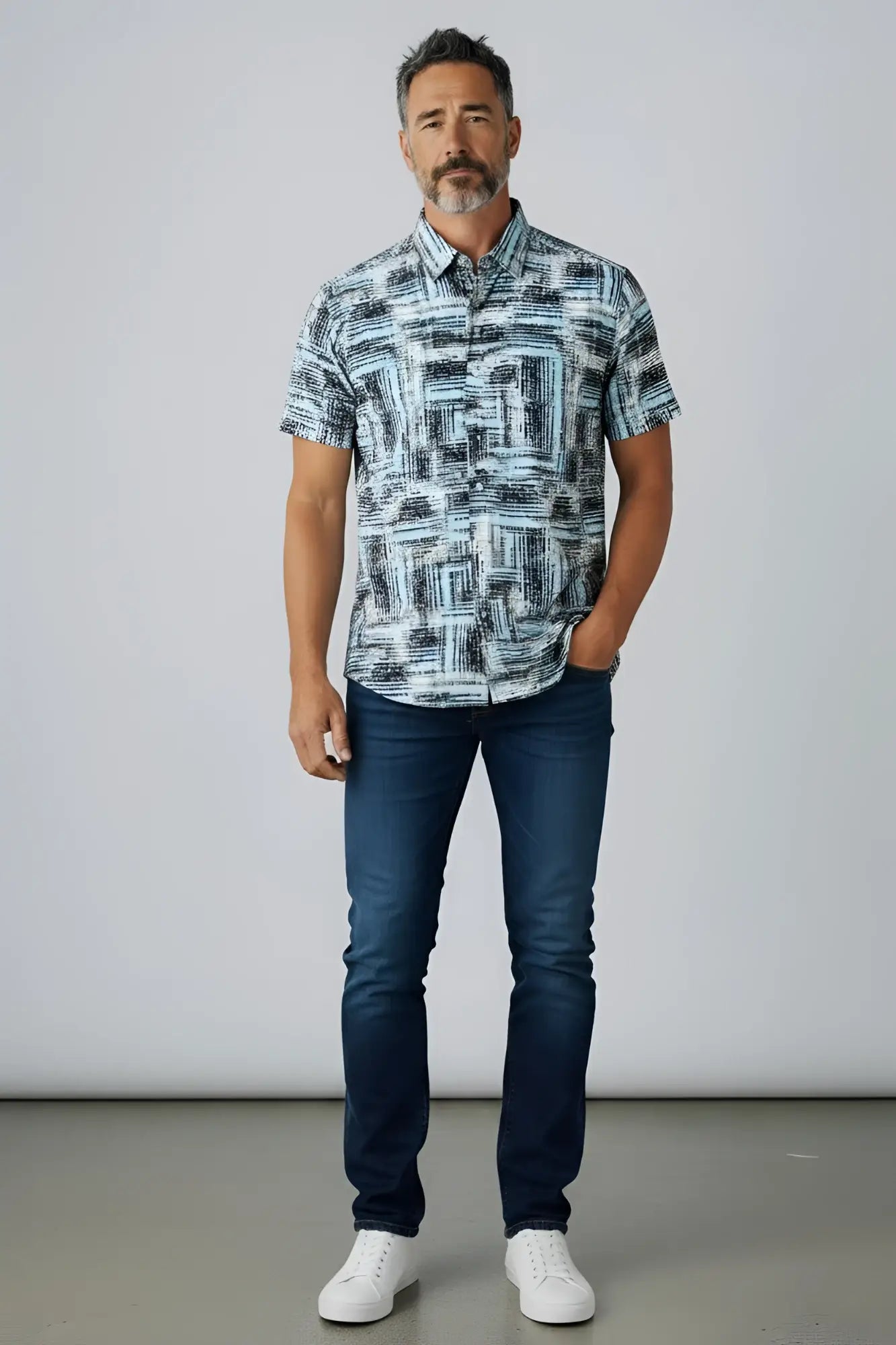 A man wearing a suslo crinkled fabric s/s shirt with an abstract gray and white geometric pattern
