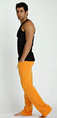 Bright orange loose-fitting pants with small white logo on thigh styled with black sustain tank top