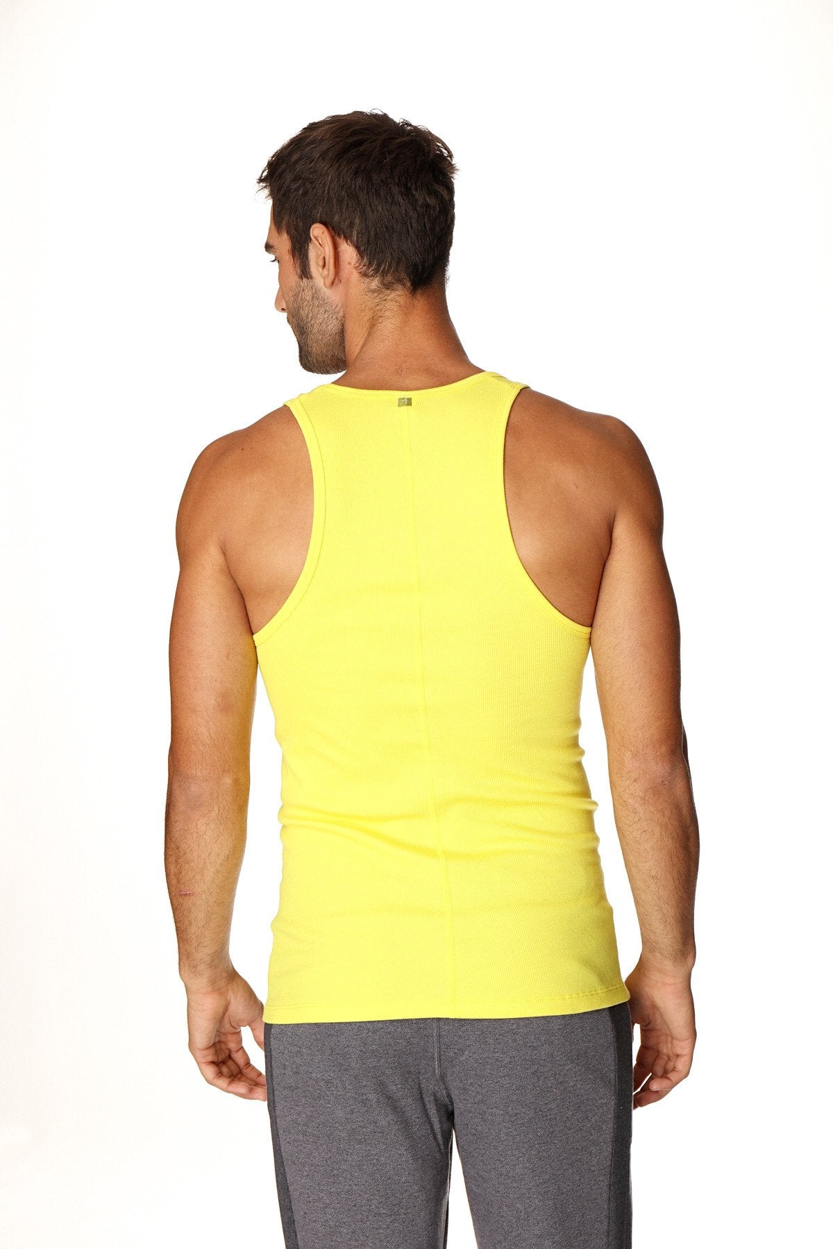 Bright yellow sleeveless athletic tank top made from sustainable fabric designed for active wear in tropic yellow