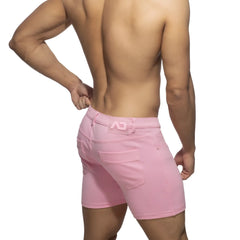 Pink denim svelte shorts with a subtle logo on the waistband shown from the back side