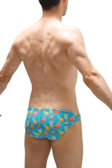 Blue swim bikini taik punta swim trunks with playful watermelon pineapple and tropical drink pattern for beach use