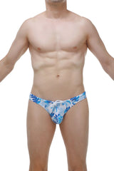 Swim thong maeha featuring blue and white tropical leaf-patterned swim trunks with a drawstring waistband