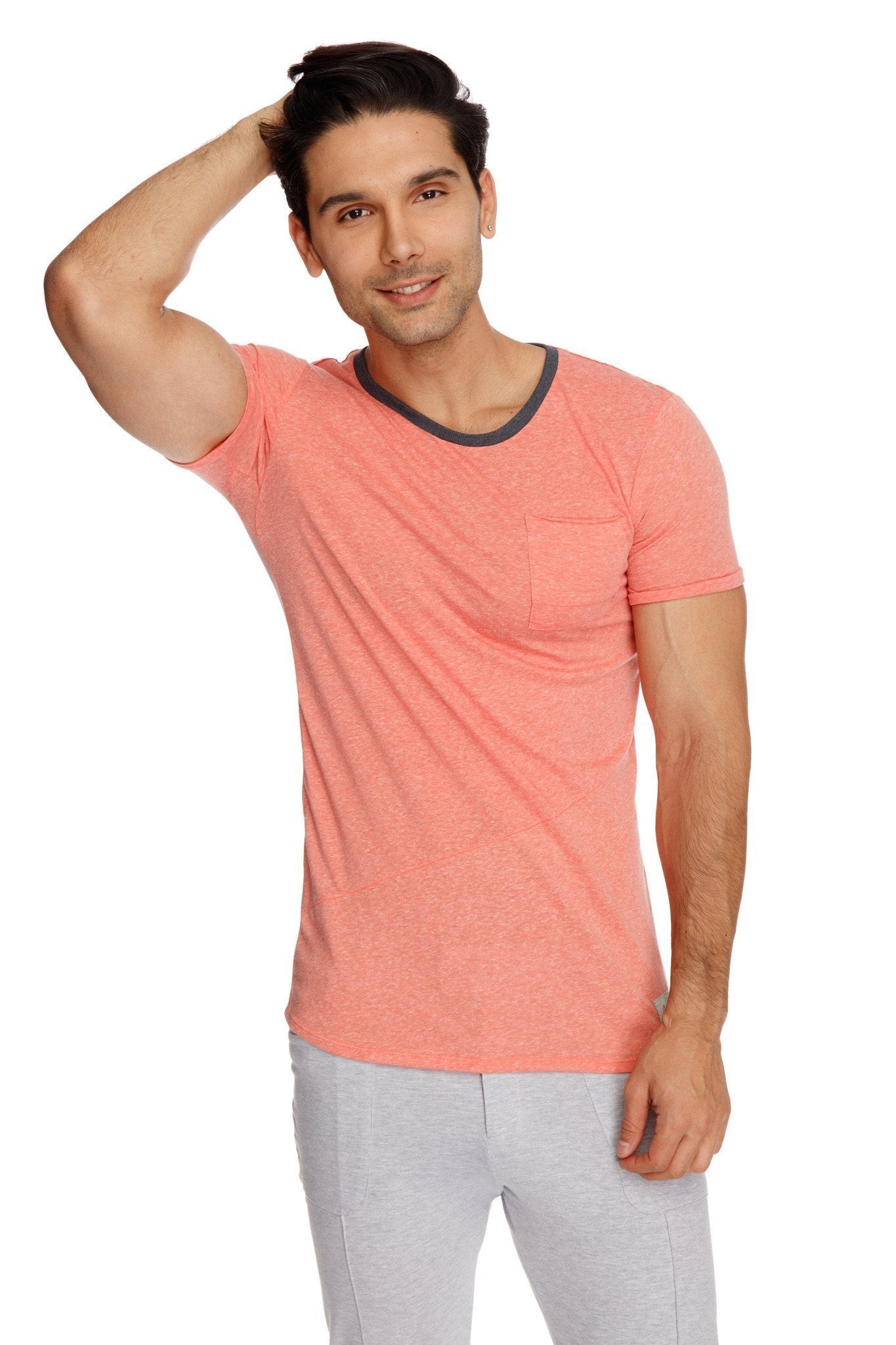 Coral short-sleeved t-shirt with dark gray ribbed crew neckline and chest pocket paired with heather grey tactical urban dress pant yoga pant