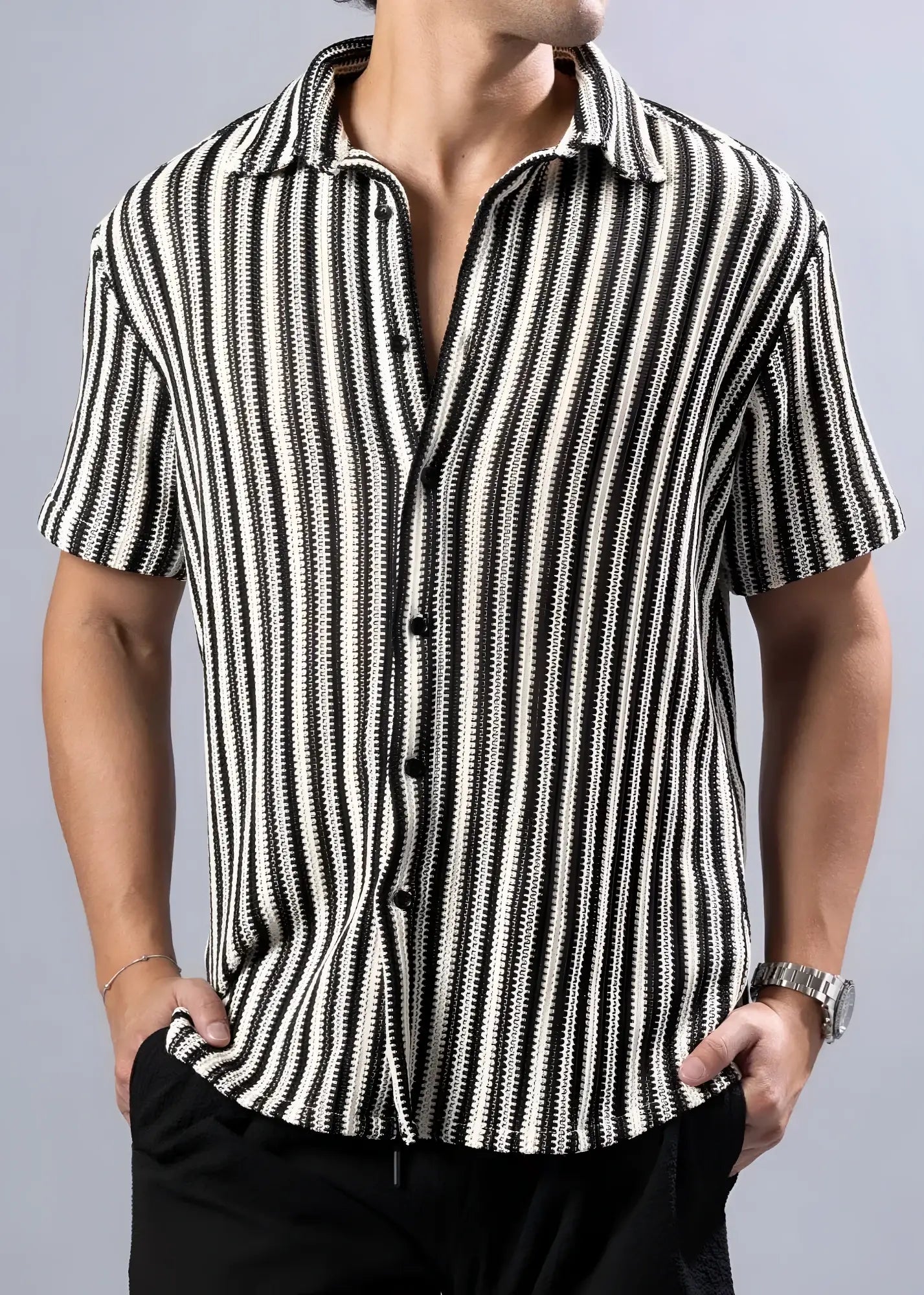 Black and white vertically striped texture knit short-sleeved button-up shirt with a textured pattern