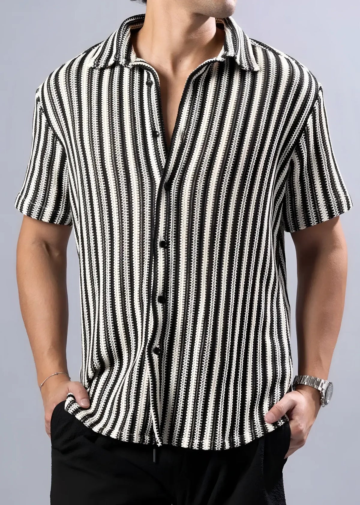 Black and white vertically striped texture knit short-sleeved button-up shirt with a textured pattern