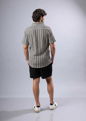 A man wearing a black and white vertically striped texture knit short-sleeved button-up shirt
