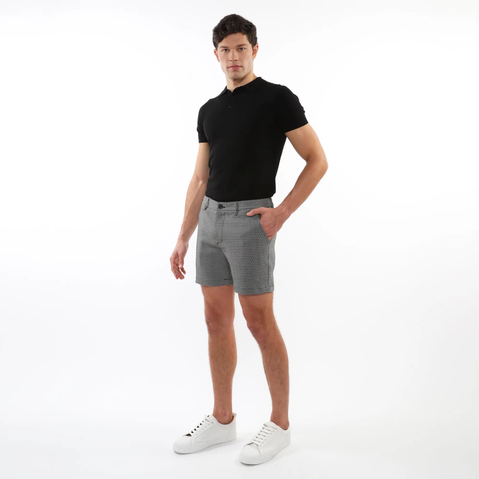 Men’s black short-sleeved polo shirt paired with textured jacquard stretch chino shorts in breathable fabric