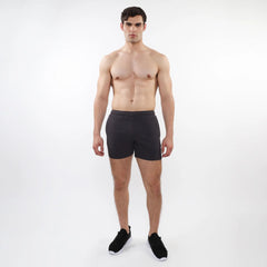 Black textured mesh stretch performance shorts with sleek form-fitting design and elastic waistband for athletics