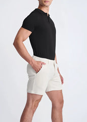 Cream-colored textured stretch knit chino shorts with a modern tailored cut and subtle side seam detailing