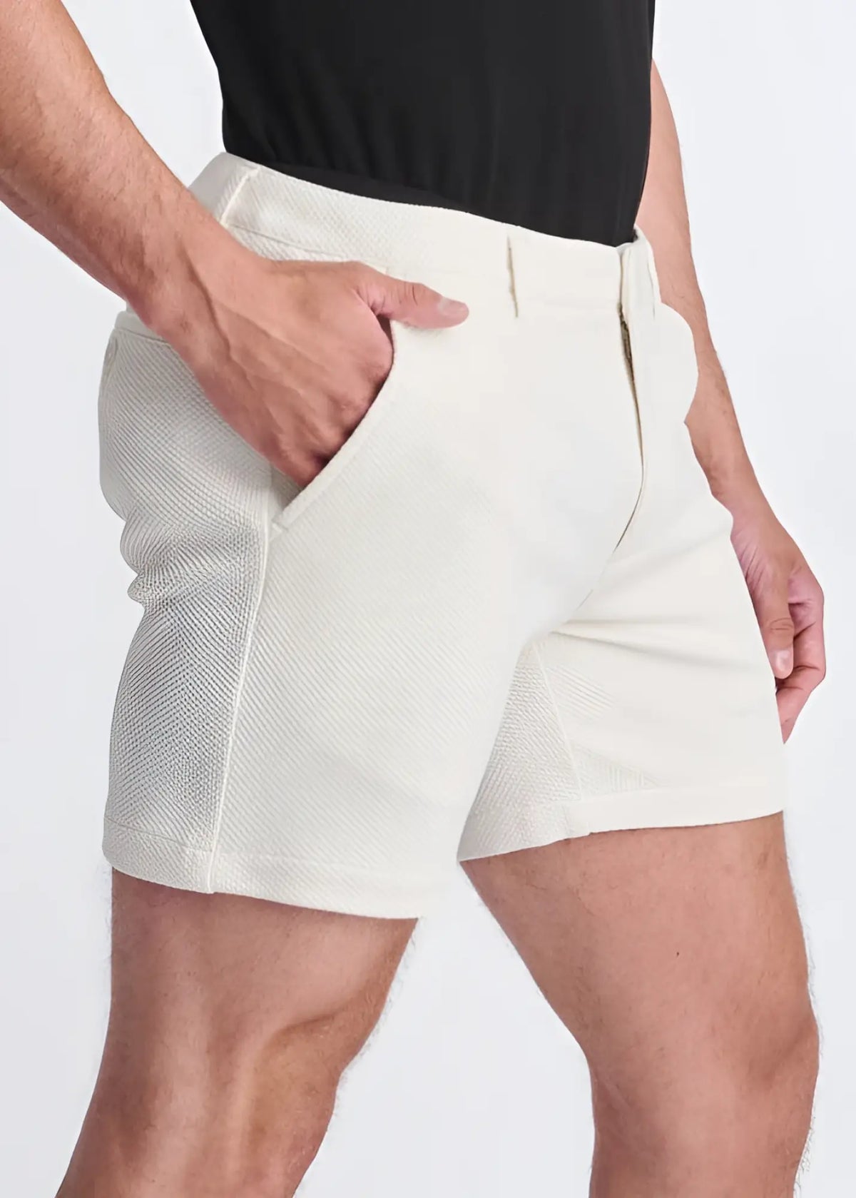 Cream-colored textured stretch knit chino shorts with tailored fit and side pockets for comfortable wear