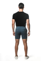 Dark teal textured stretch knit chino shorts with subtle gradient fade and two back pockets shown from the back