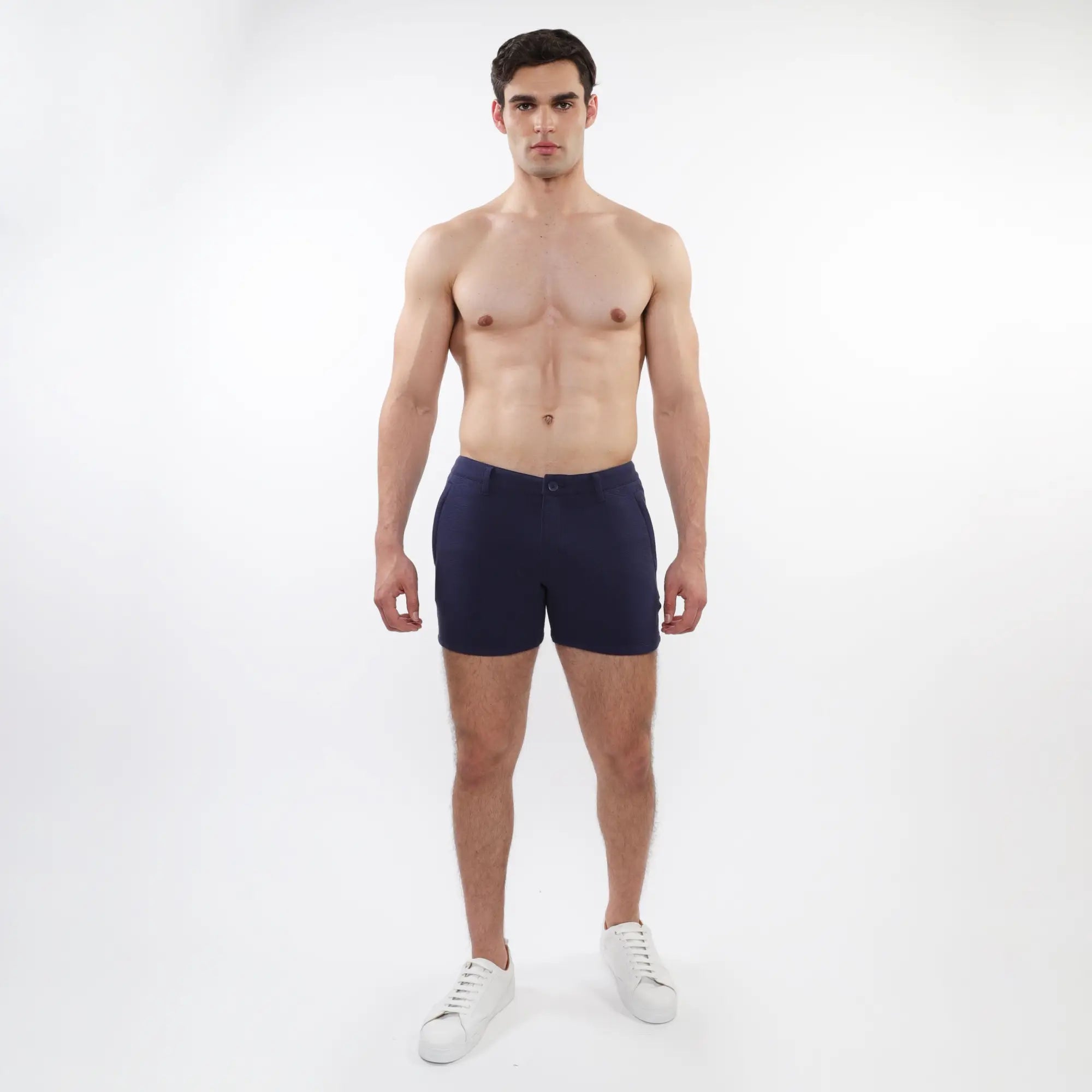 Navy blue textured stretch knit chino shorts with button closure and zip pockets featuring a clean modern design