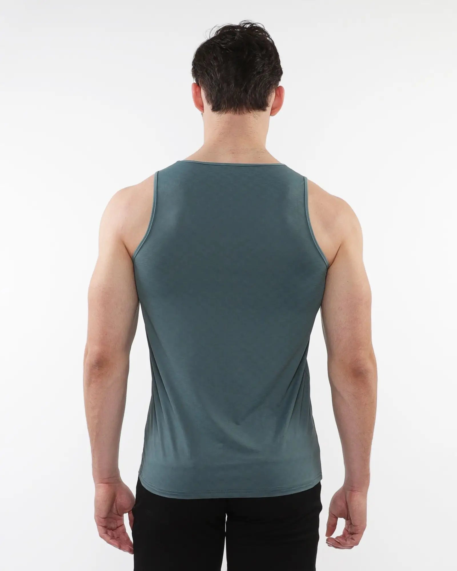 A sleek dark teal sleeveless tank top made of textured stretch mesh performance fabric with a smooth fit