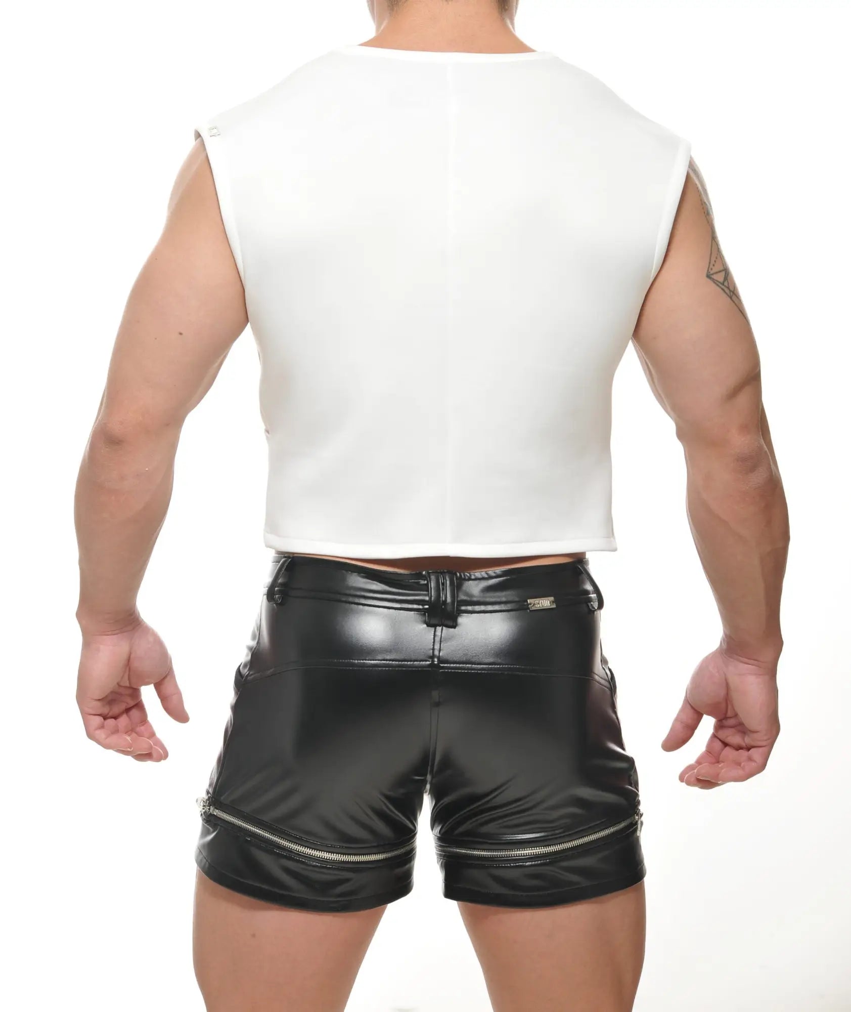 Back view of black patent leather theta crop top shorts with zipper accents and central back belt loop