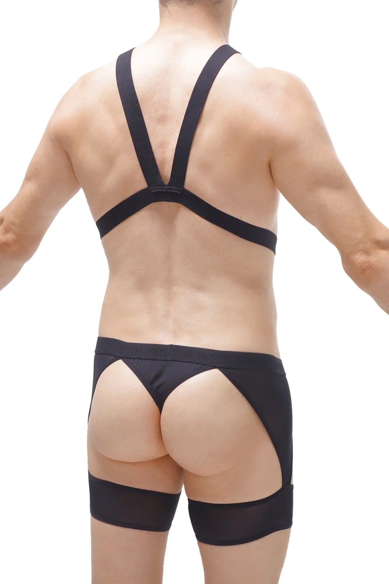 Black satin thong harness mece briefs with wide supportive straps and sheer mesh side panels visible from the back