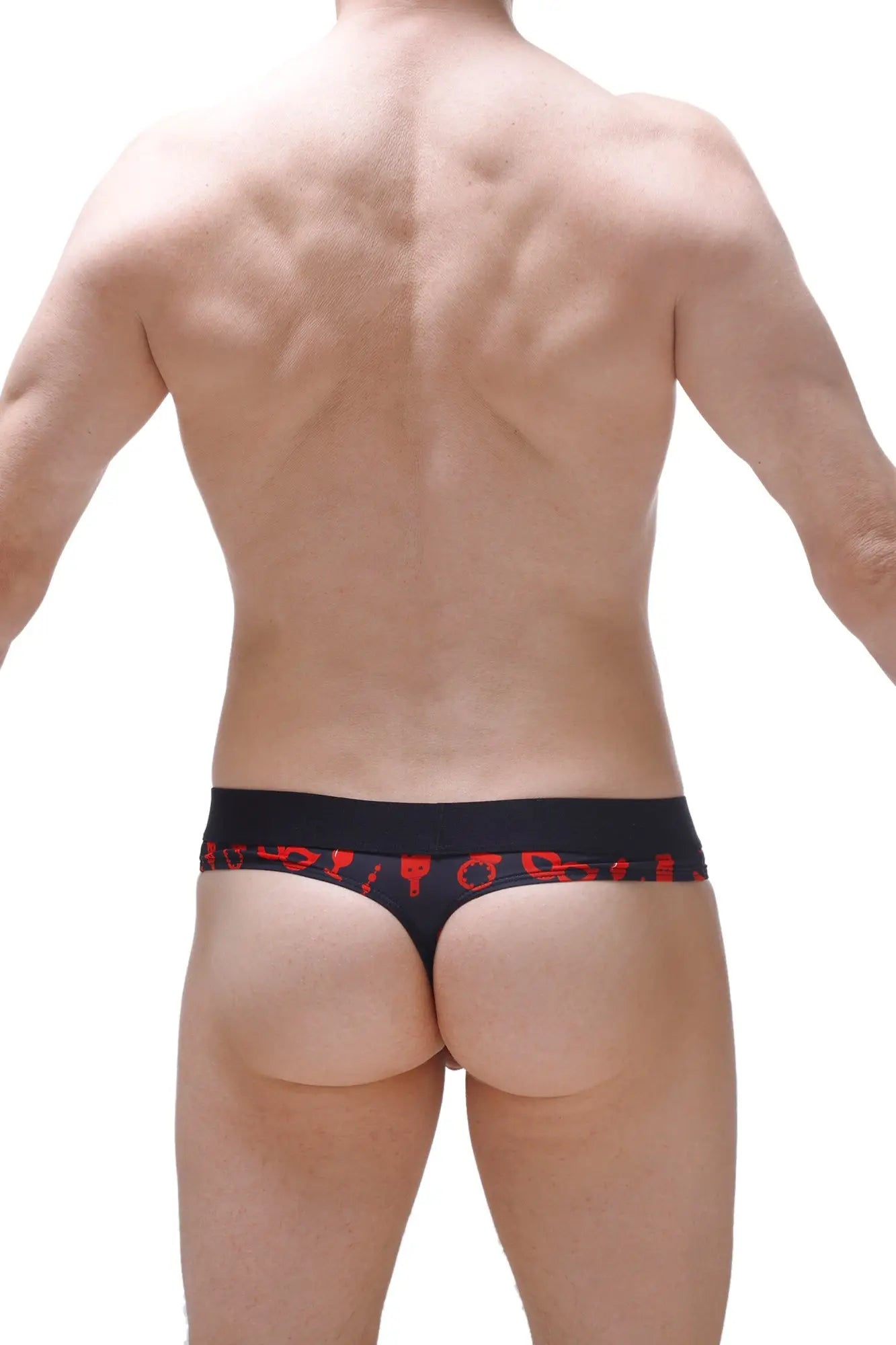 Black thong with red symbolic patterns along the waistband featuring a thong hole cockring for boudoir use back view