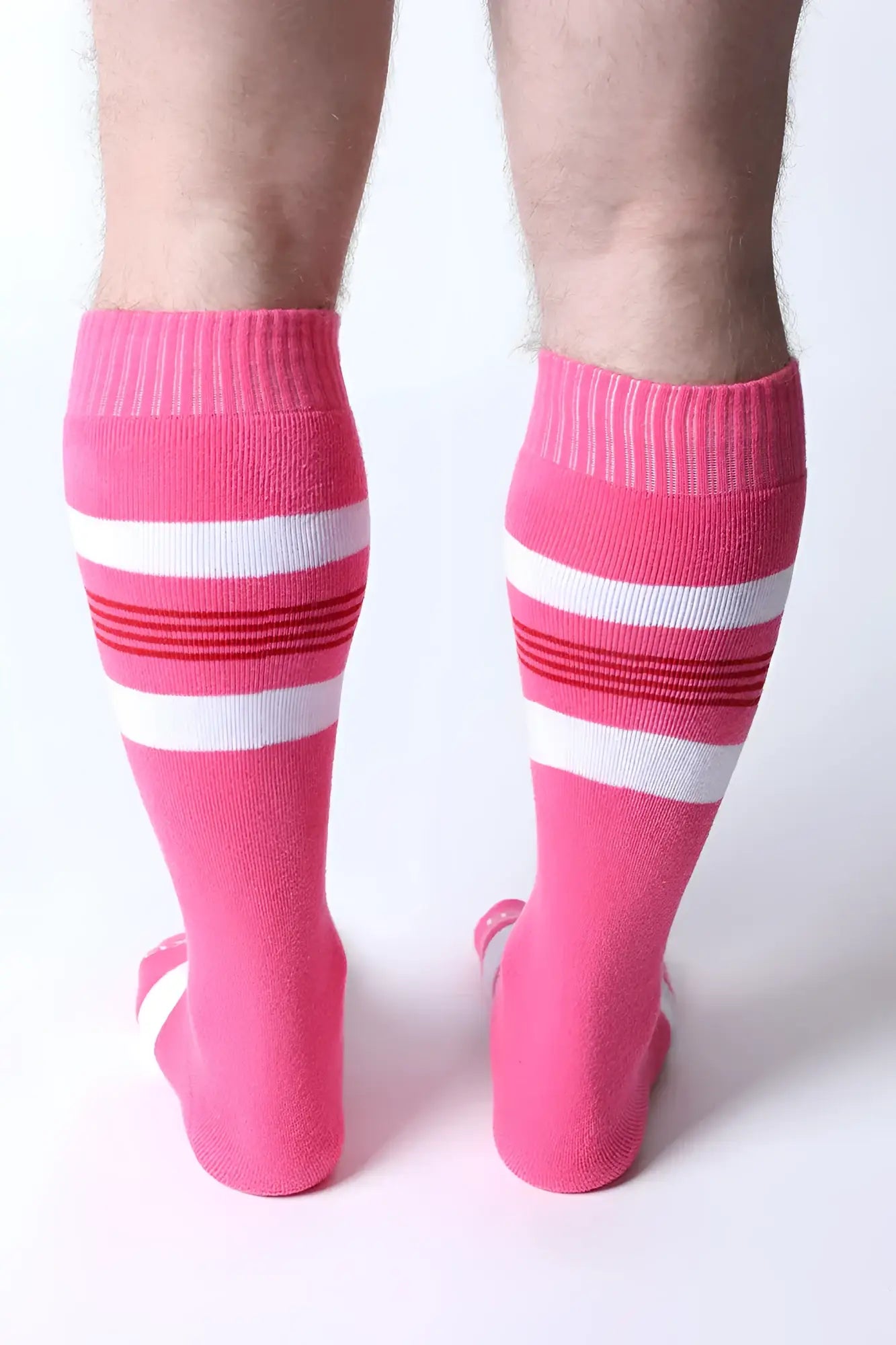 Tight end knee high socks featuring bright pink color with white and red striped bands for stylish comfort