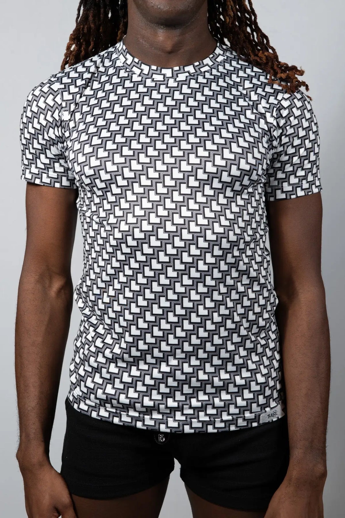 Black and white geometric patterned short sleeve rash guard tee designed for sun protection and active wear