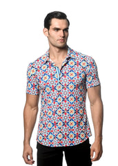 A man wearing a tile printed performance short-sleeved shirt with vibrant blue red and white geometric patterns and contrast placket
