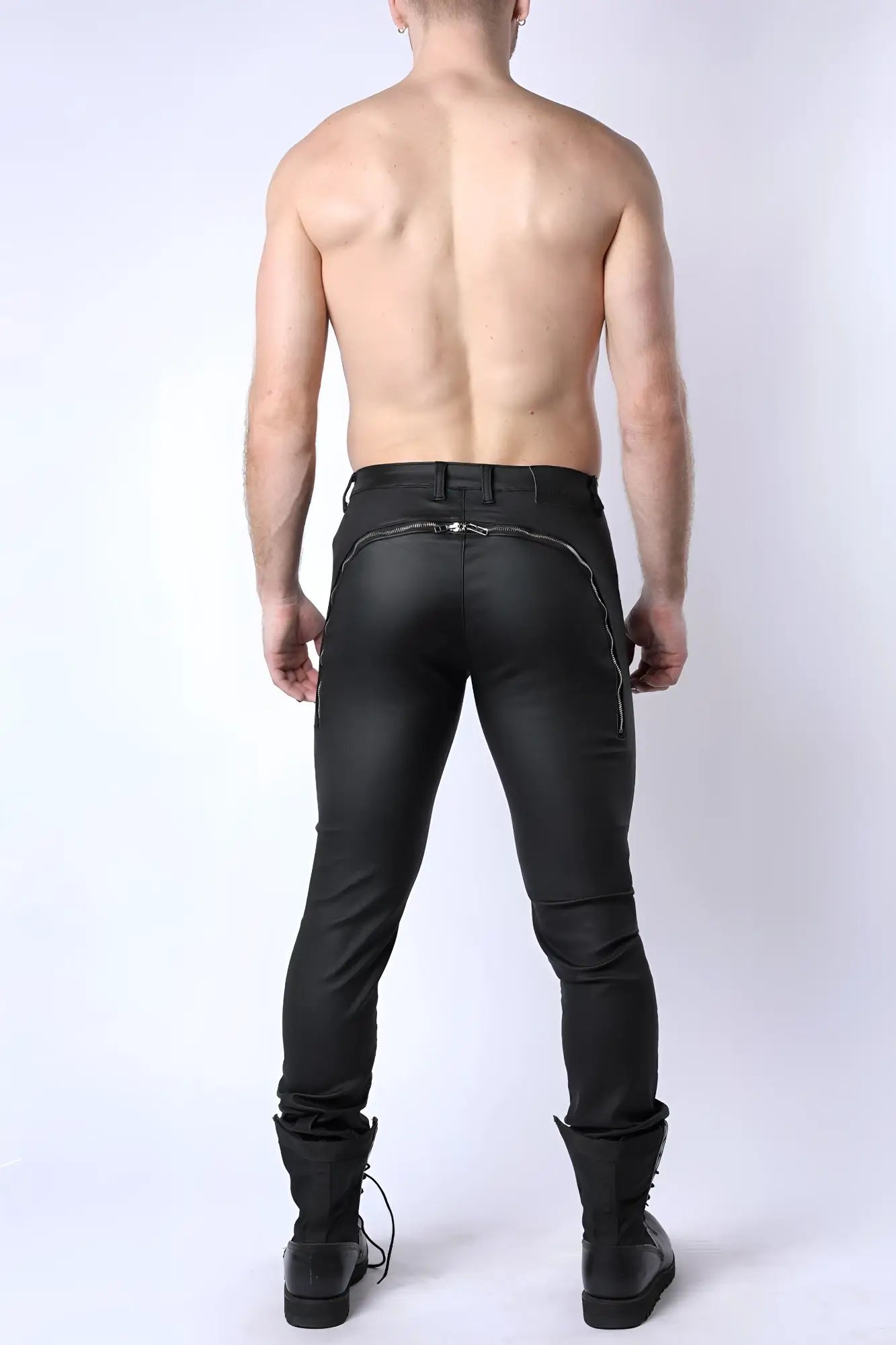 Black leather toro zipper pant with a sleek form-fitting design and silver zipper accents along the back seam