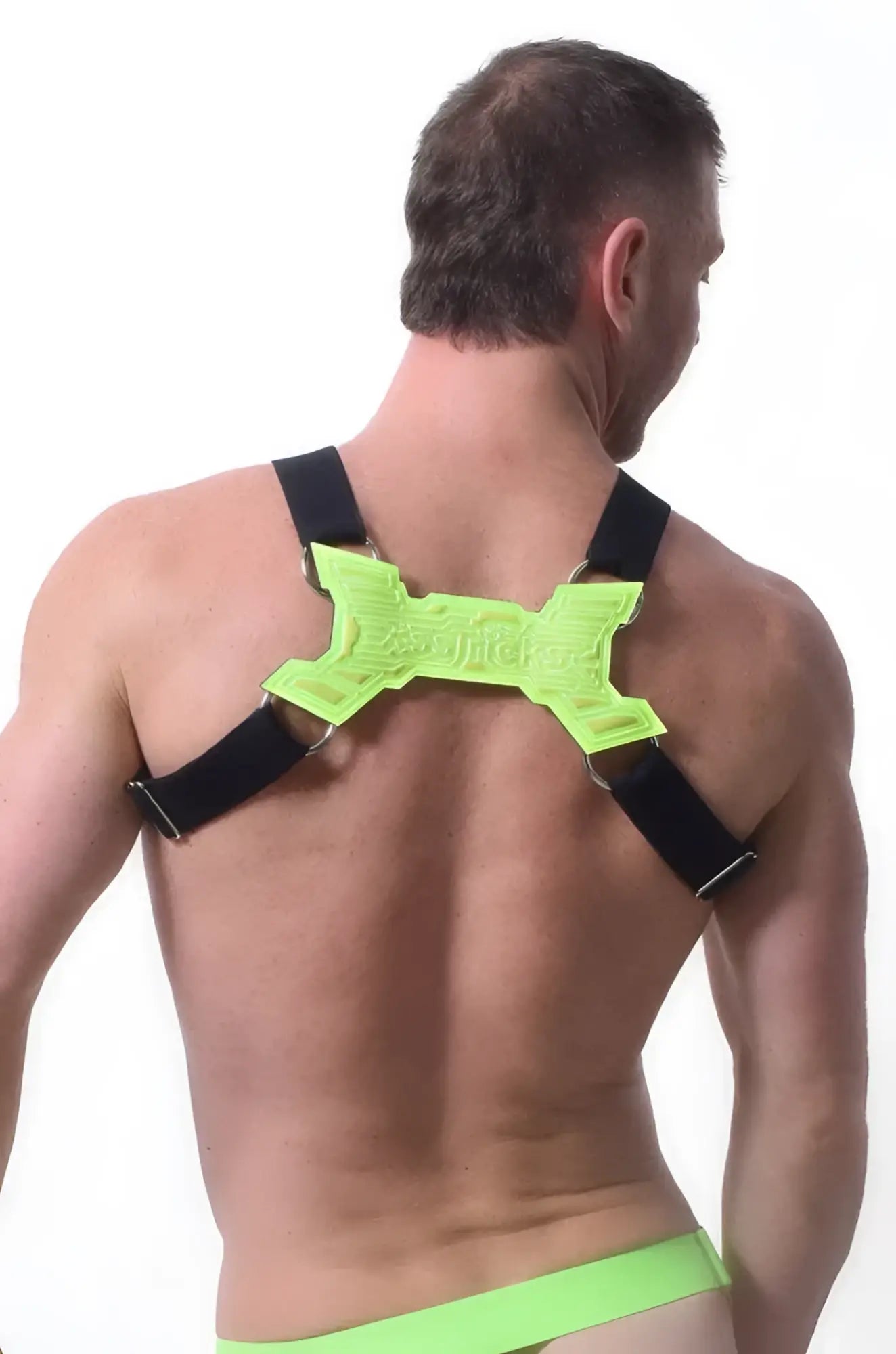 Neon green x-shaped back support with black straps on the back side of the transistor harness product