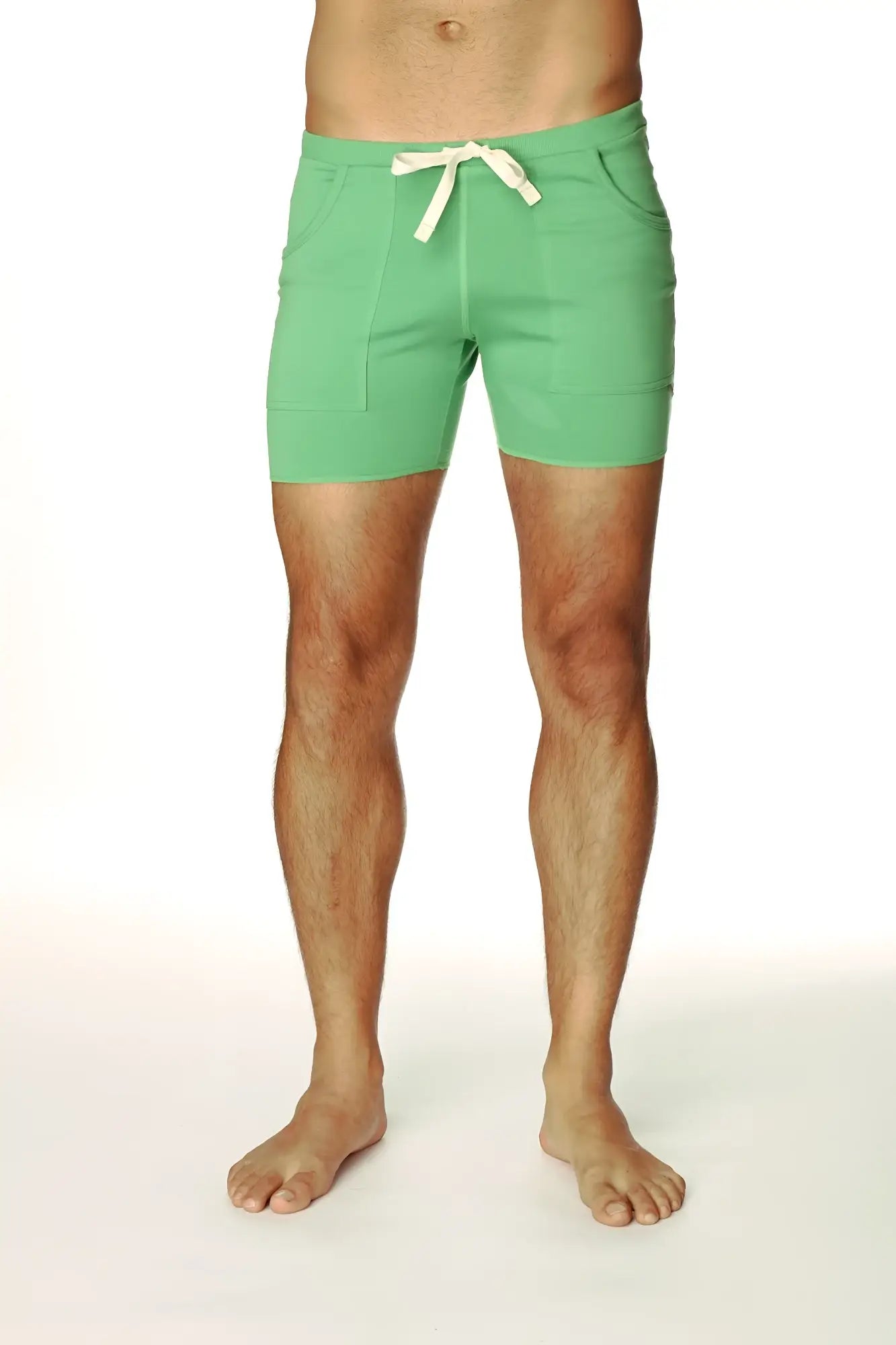 Transition yoga short in bamboo green with mint green fabric, cream drawstring tie, and two front pockets