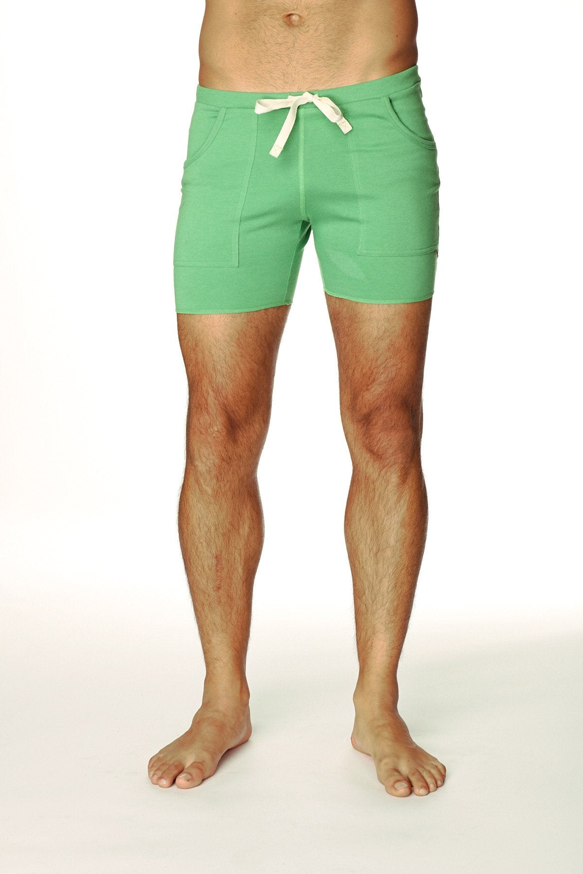 Transition yoga short in bamboo green with mint green fabric, cream drawstring tie, and two front pockets