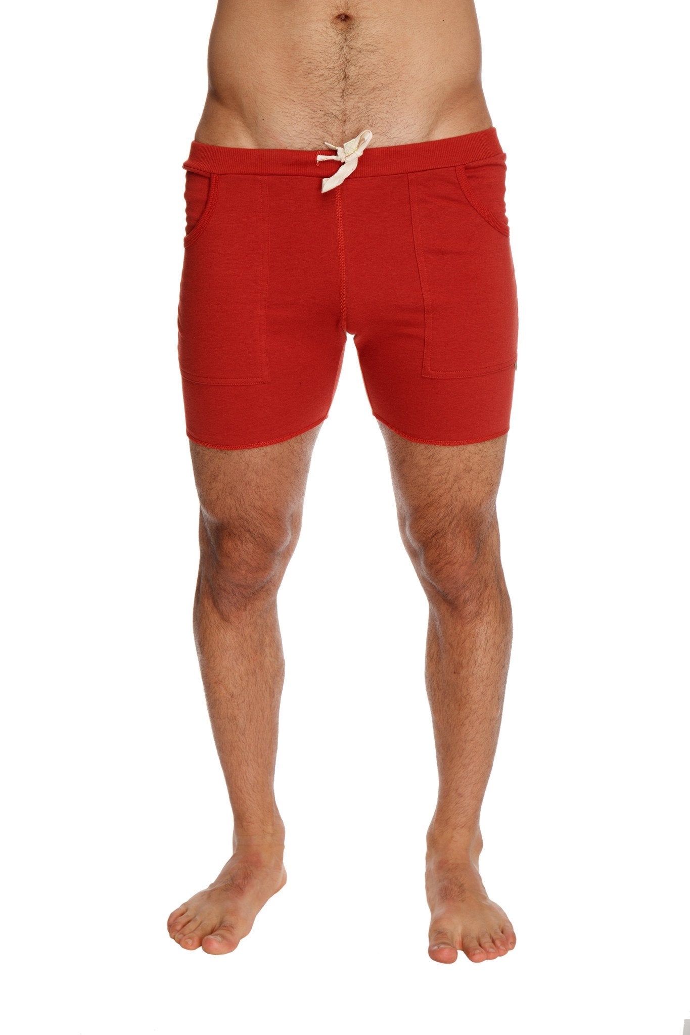 Transition yoga short in cinnabar red featuring a white drawstring and two side pockets for athletic use