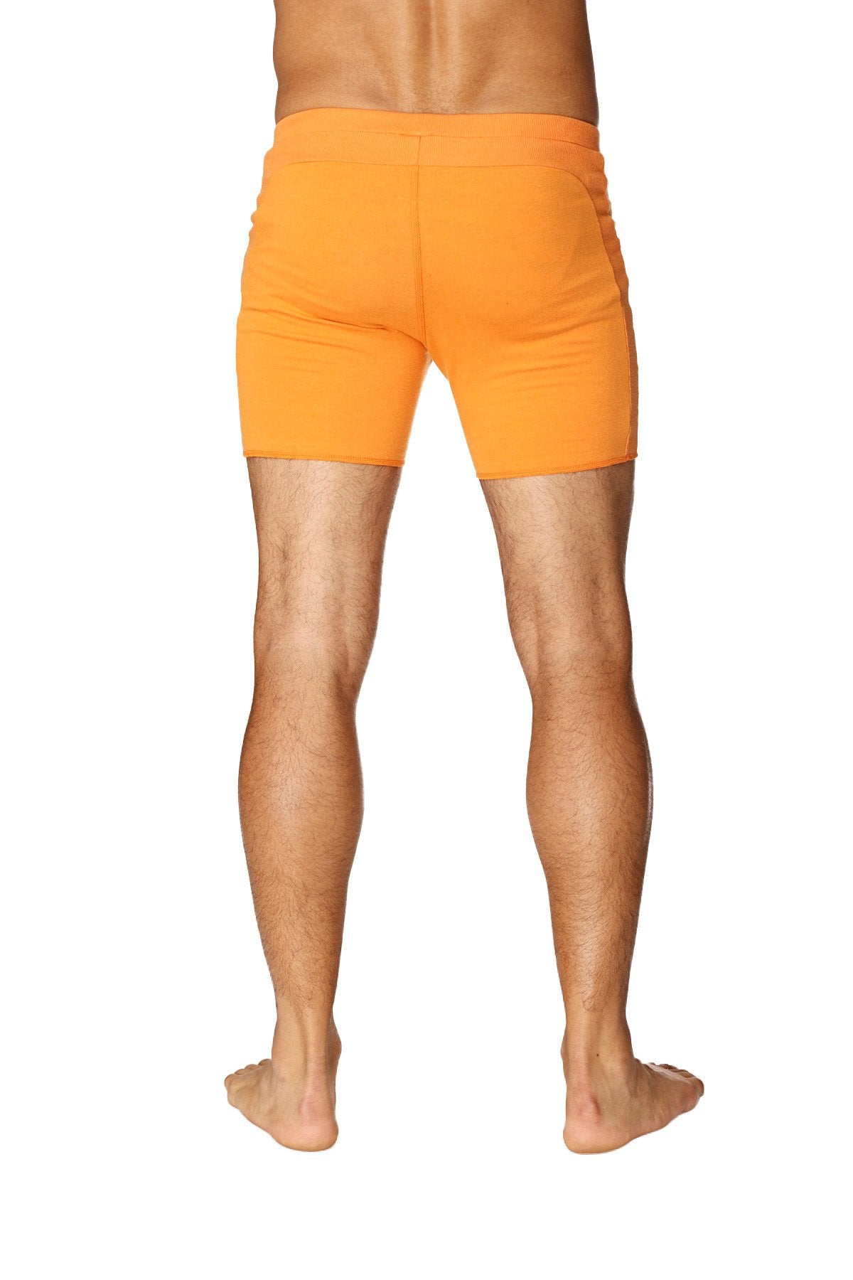Bright orange form-fitting transition yoga shorts with smooth fabric finish designed for athletic use