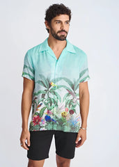 A vibrant turquoise tropical print short-sleeved modal shirt with birds and lush foliage titled tropics border print s/s modal shirt