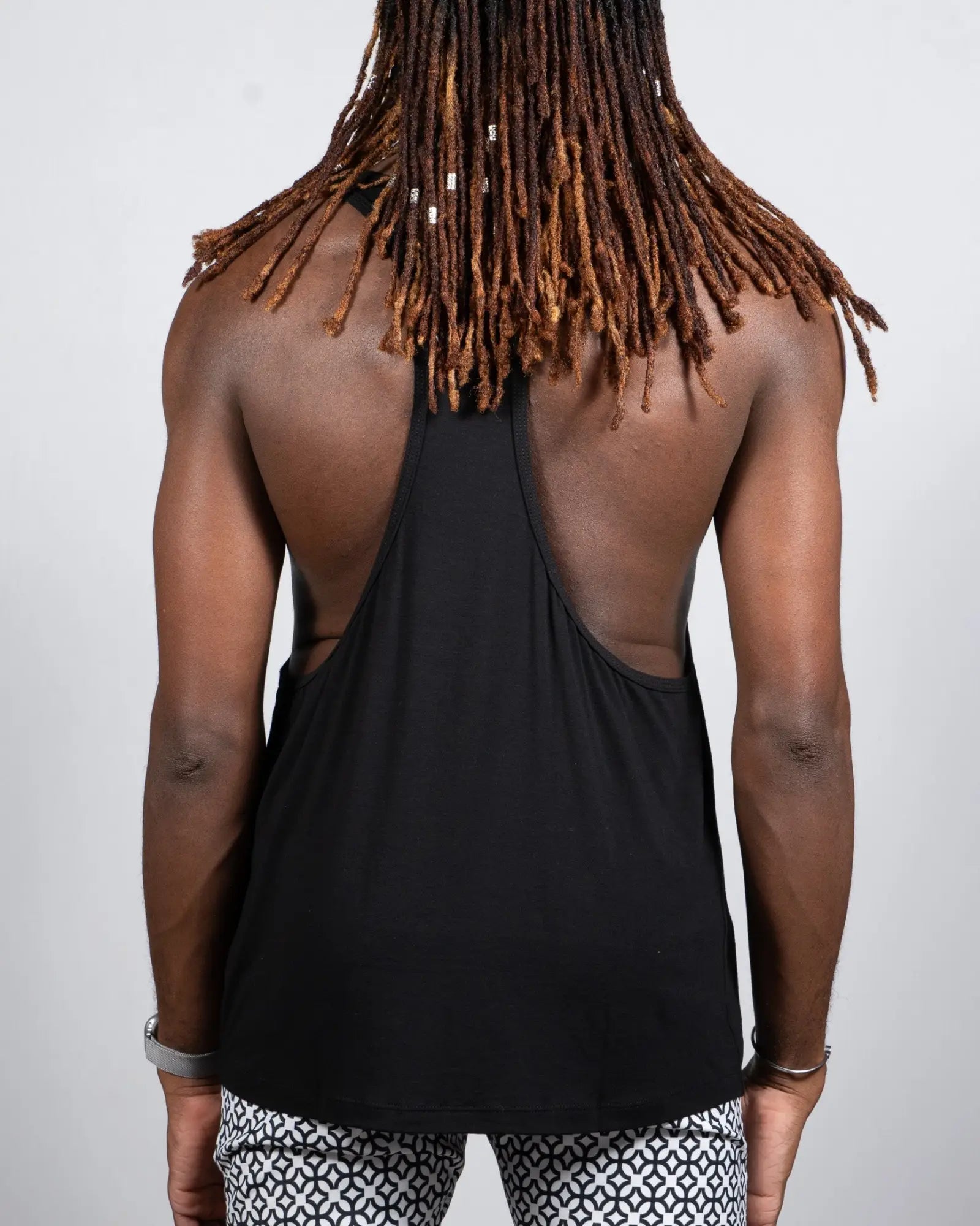 Black tulio racerback tank top in cotton with a cutout back design shown from the back side