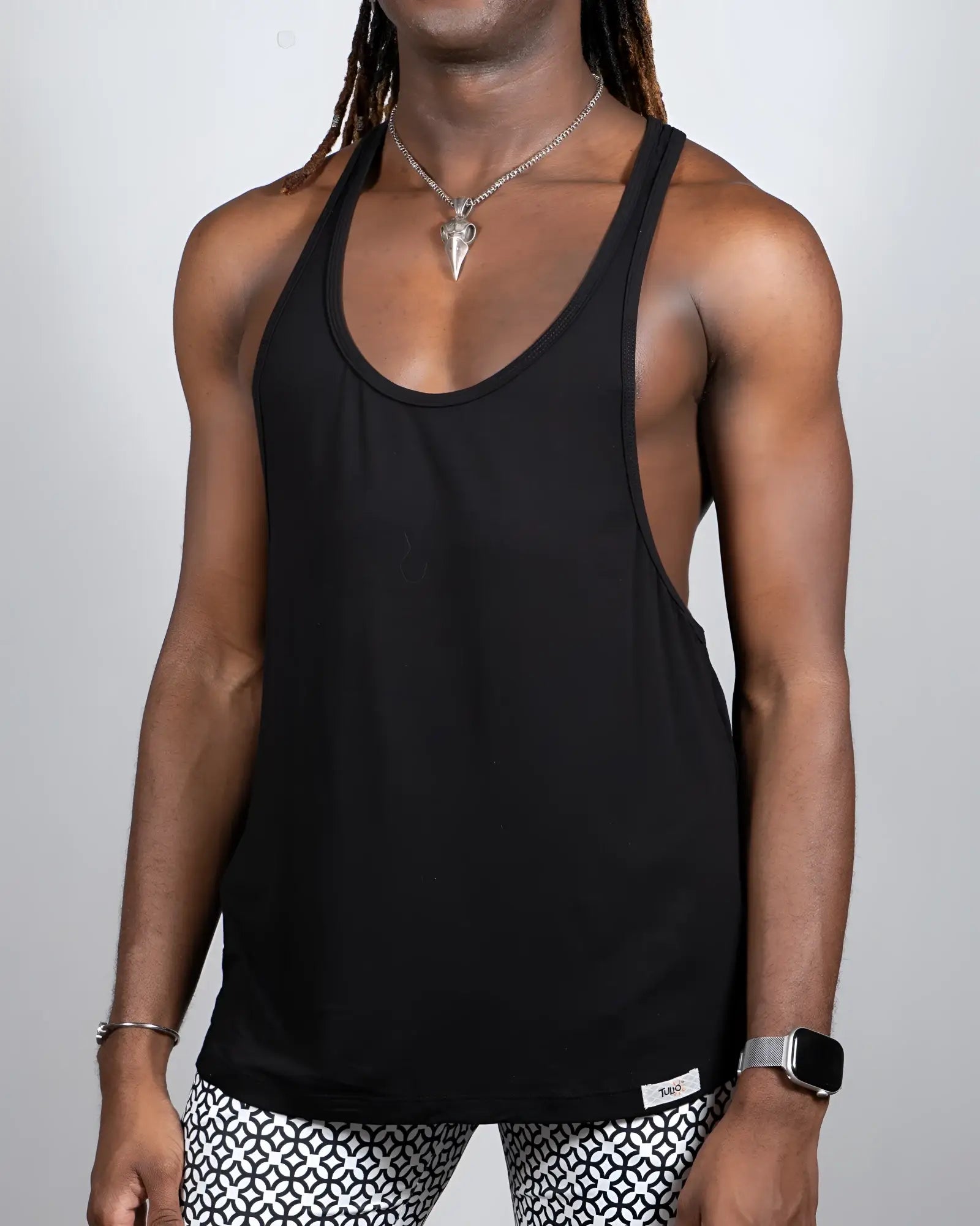 Black Tulio racerback tank top with a minimalist design shown from the back available in 4 colors