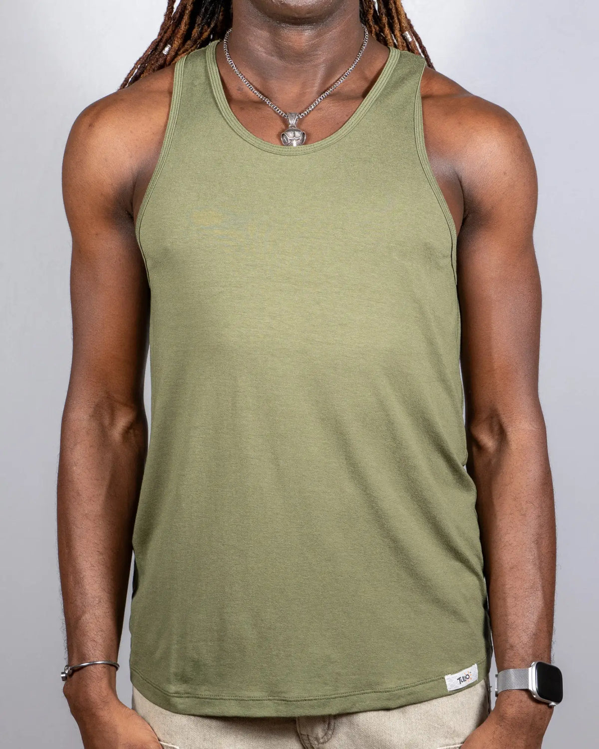 Olive green sleeveless ribbed tank top with a white Tulio brand tag at the bottom right hem