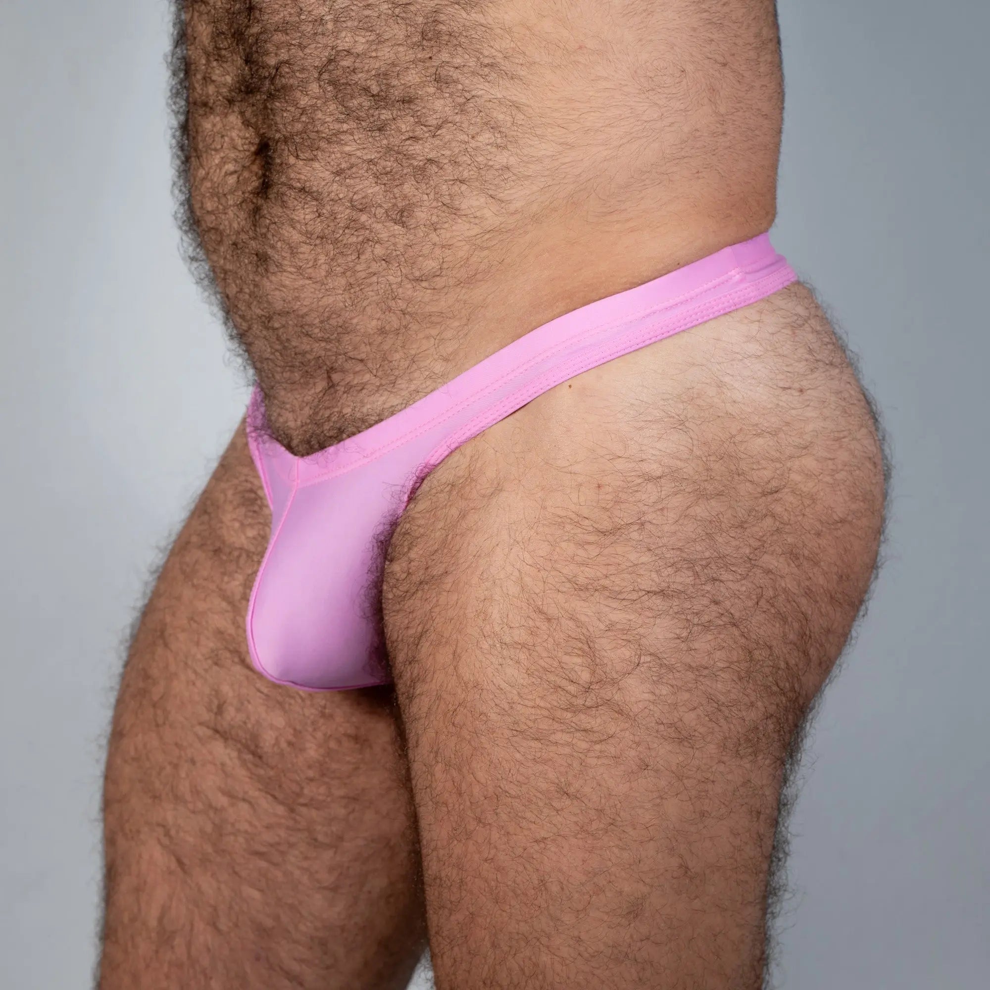 Tulio swim thong solid pink mesh design showing the back side of the swimwear product
