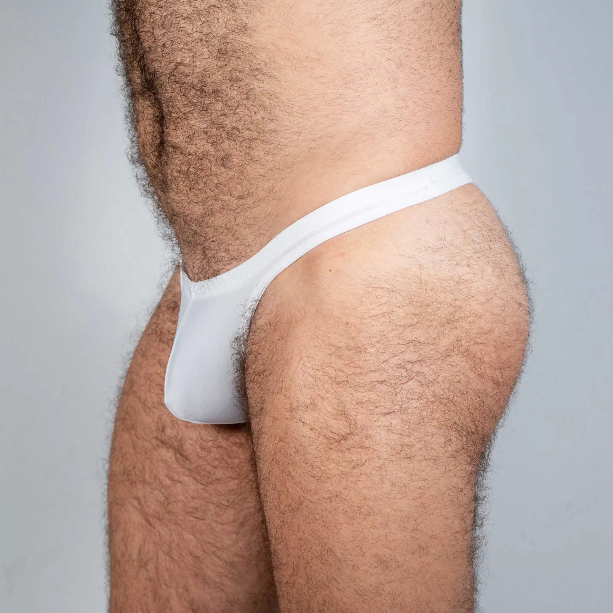 White cotton tulio swim thong with snug form-fitting design in solids collection shown from the back side